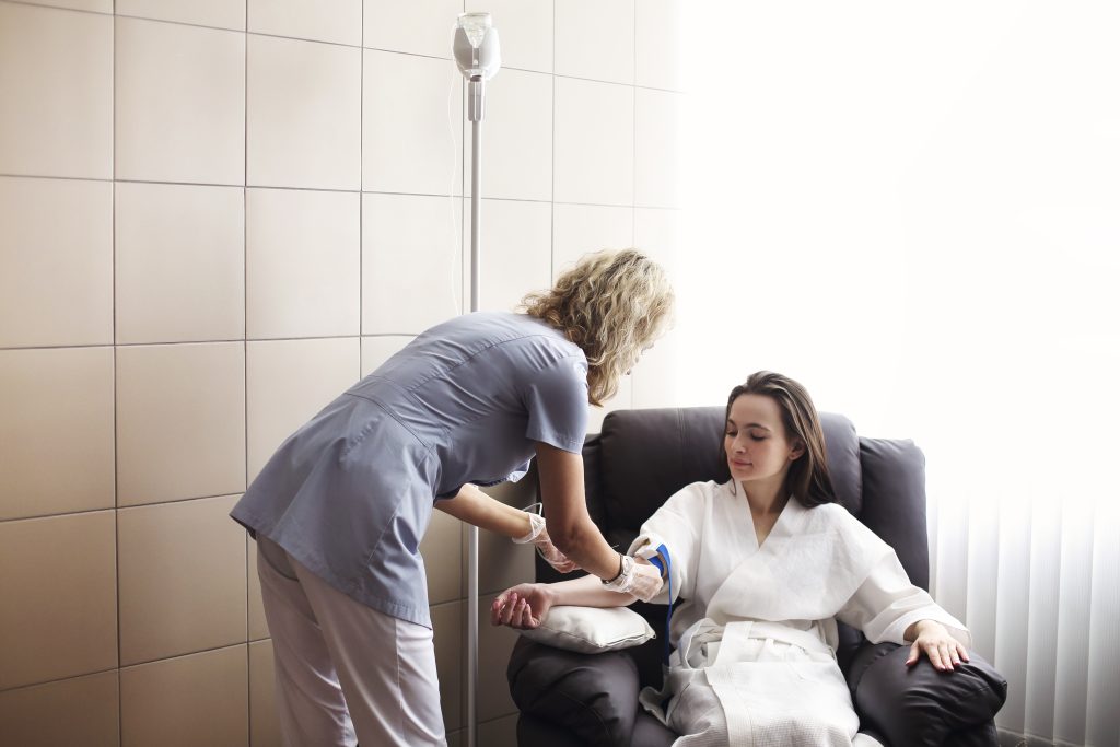 Nurse preparing patient for intravenous therapy